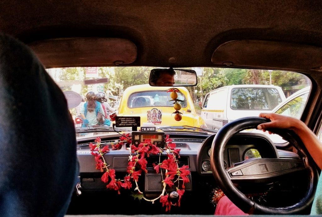 Take the iconic yellow taxi cab as part of the places to visit in Kolkata.