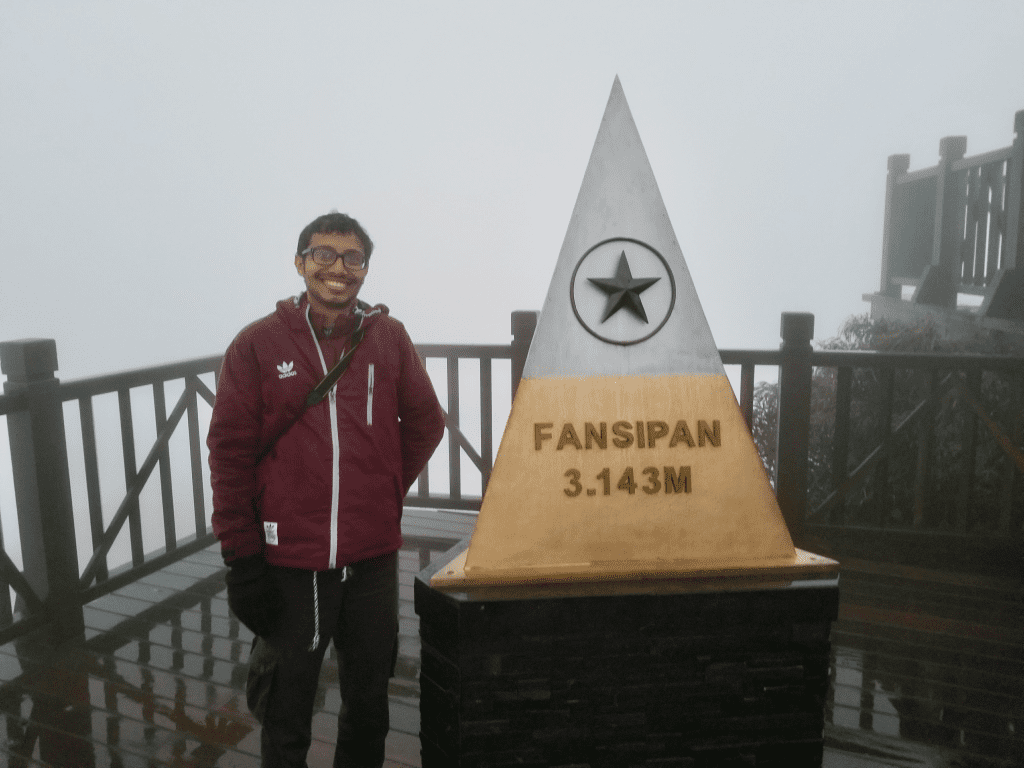 awalkintheworld author on top of Mount Fansipan