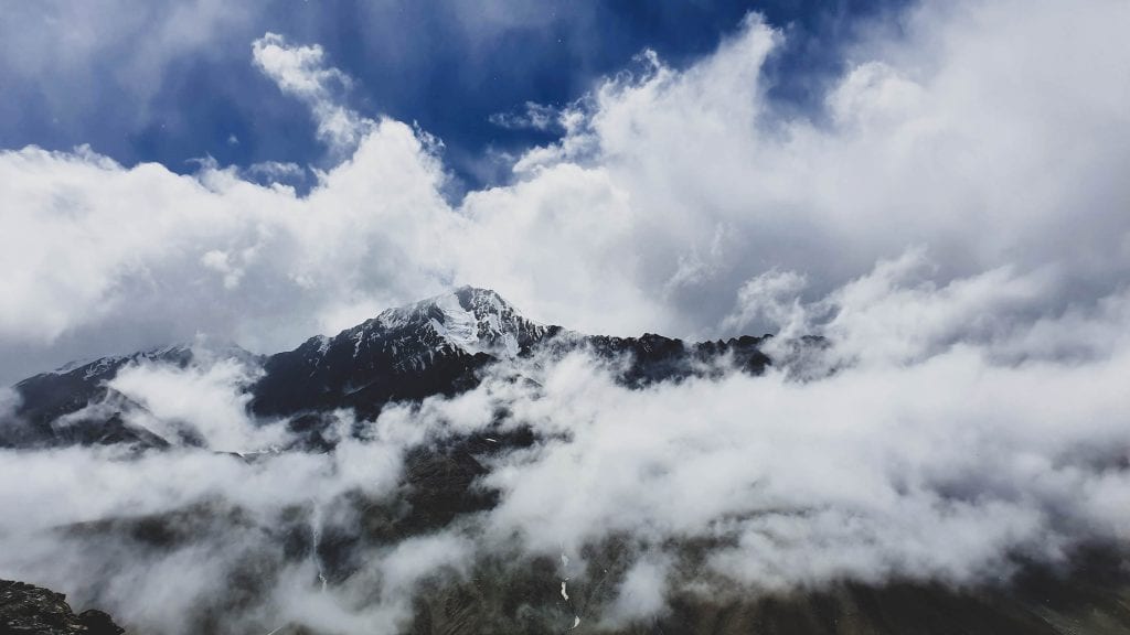 Barren mountains covered with clouds in Spiti Valley. 