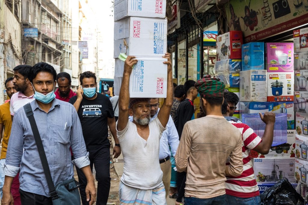 Old man carrying object in old Dhaka